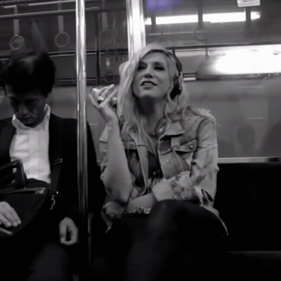 a woman wearing headphones is sitting next to a man