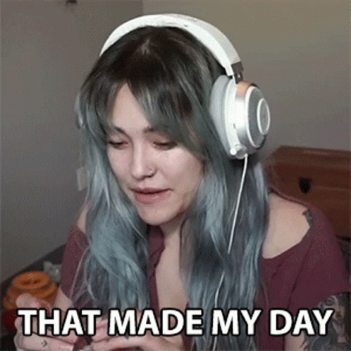 A Woman Wearing Headphones Is Sitting On A Bed And Says `` That Made My Day '' . GIF