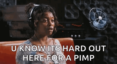A Woman Wearing Headphones Is Sitting On A Couch And Saying `` U Know Its Hard Out Here For A Pimp '' GIF