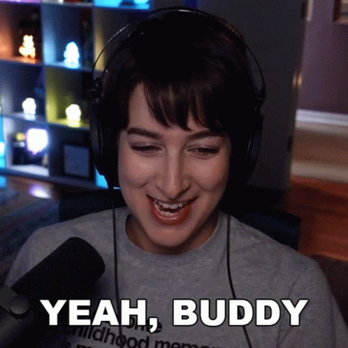 A Woman Wearing Headphones Is Smiling And Says " Yeah Buddy " GIF