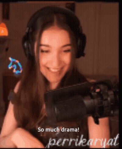A Woman Wearing Headphones Is Smiling In Front Of A Microphone With The Words So Much Drama Written Below Her GIF