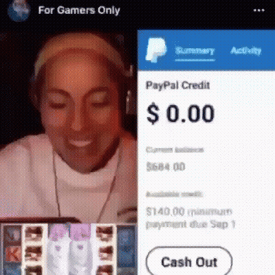 A Woman Wearing Headphones Is Smiling While Playing A Video Game On A Cell Phone . GIF