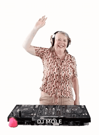 A Woman Wearing Headphones Is Standing In Front Of A Dj Mole Machine GIF