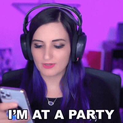 A Woman Wearing Headphones Looks At Her Phone With The Words I 'M At A Party Below Her GIF