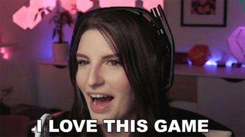 A Woman Wearing Headphones Says " I Love This Game " In Front Of A Microphone GIF