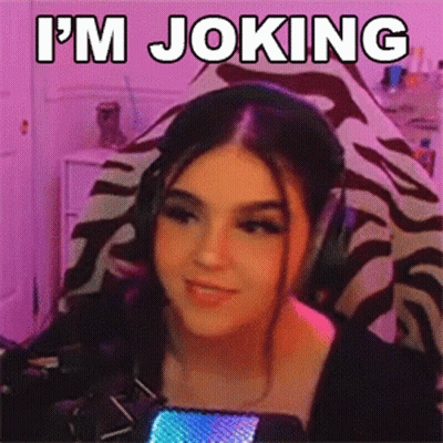 A Woman Wearing Headphones Says I 'M Joking In Front Of A Microphone . GIF