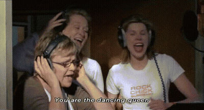 A Woman Wearing Headphones Says " You Are The Dancing Queen " While Another Woman Laughs GIF