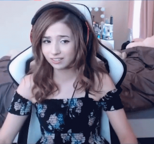 A Woman Wearing Headphones Sits In A White Chair GIF
