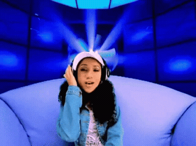 A Woman Wearing Headphones Sitting On A Couch GIF