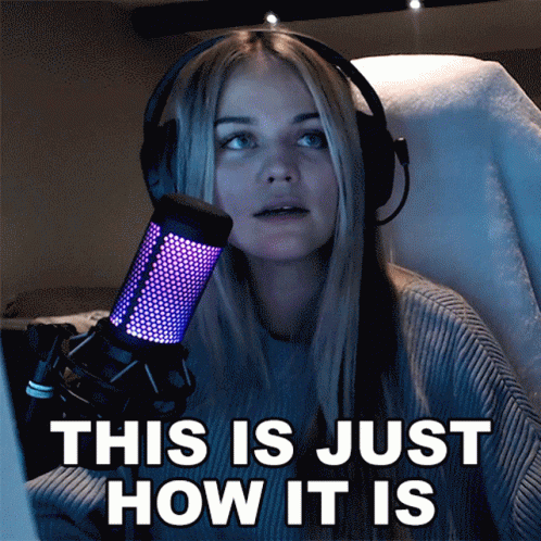 A Woman Wearing Headphones Stands In Front Of A Microphone And Says This Is Just How It Is GIF
