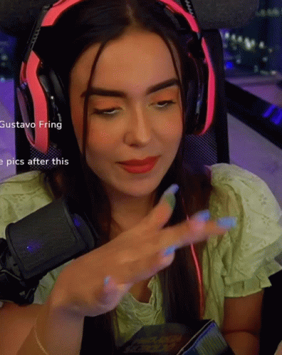 A Woman Wearing Headphones With The Name Gustavo Fring Visible GIF