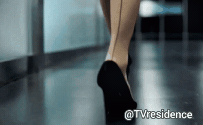 A Woman Wearing High Heels Is Walking Down A Hallway With The Caption @Tvresidence GIF