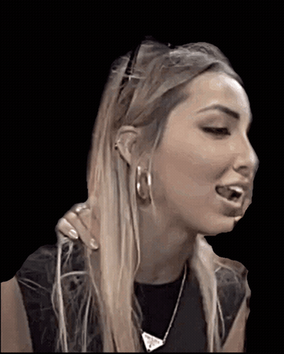 A Woman Wearing Hoop Earrings And A Necklace Is Making A Face GIF