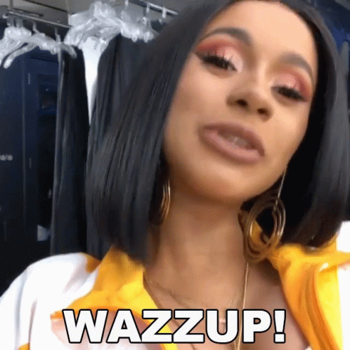 A Woman Wearing Hoop Earrings And A Yellow Shirt Says Wazz Up GIF