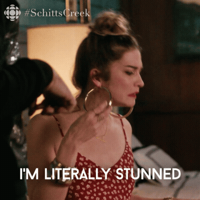 A Woman Wearing Hoop Earrings Says I 'M Literally Stunner GIF