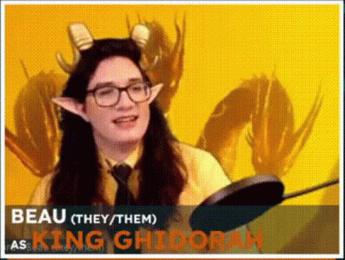 A Woman Wearing Horns And Glasses Is Holding A Frying Pan And Talking . GIF