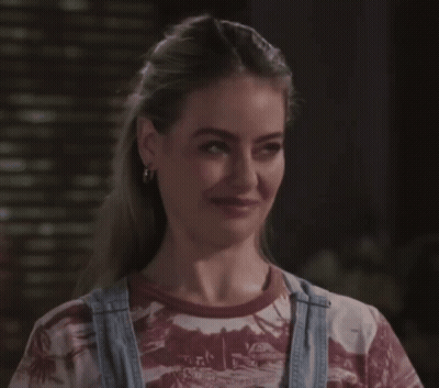 A Woman Wearing Overalls And A T-Shirt That Says Hawaii On It GIF