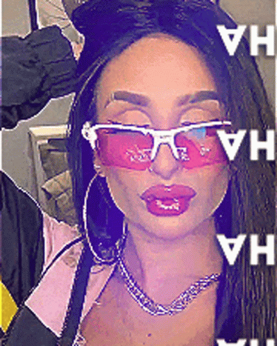 A Woman Wearing Pink Sunglasses And Hoop Earrings Has The Word Ha Written On Her Face GIF