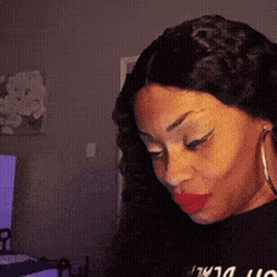 A Woman Wearing Red Lipstick And Hoop Earrings Is Wearing A Black Shirt That Says ' I Love You ' On It GIF