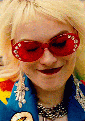 A Woman Wearing Red Sunglasses And A Blue Jacket GIF