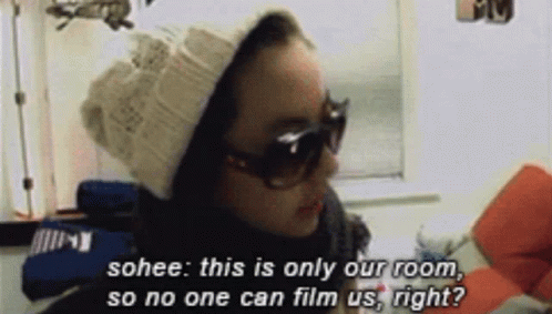 A Woman Wearing Sunglasses And A Beanie Says Sohee This Is Only Our Room So No One Can Film Us Right ? GIF