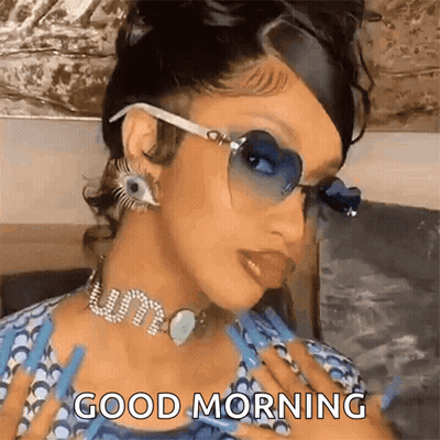 A Woman Wearing Sunglasses And A Choker Is Giving A Good Morning Message . GIF
