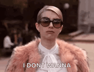 A Woman Wearing Sunglasses And A Fur Coat Is Talking . GIF