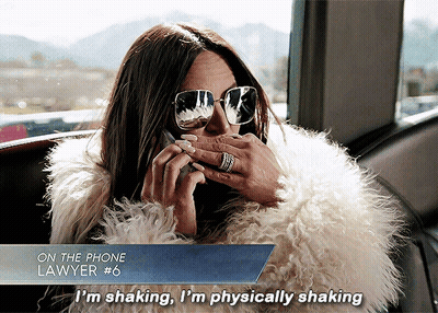 A Woman Wearing Sunglasses And A Fur Coat Talking On A Phone GIF