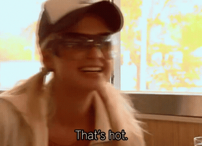 A Woman Wearing Sunglasses And A Hat Is Smiling And Saying That 'S Hot GIF