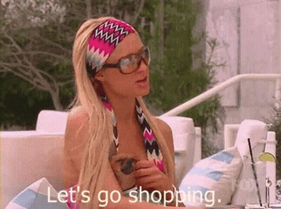 A Woman Wearing Sunglasses And A Headband Says Let 'S Go Shopping . GIF