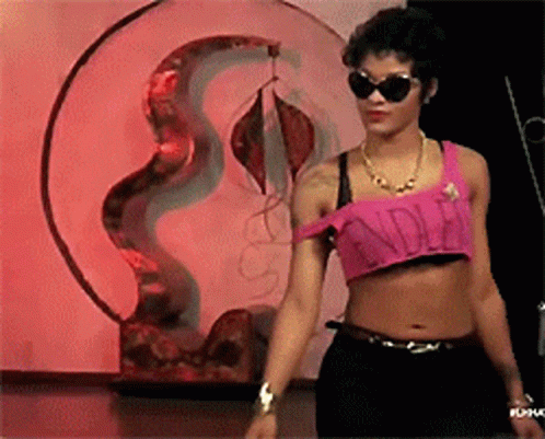 A Woman Wearing Sunglasses And A Pink Crop Top That Says ' Cinderella ' On It GIF
