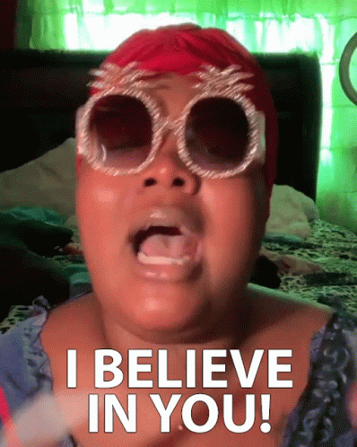 A Woman Wearing Sunglasses And A Red Hat Is Saying I Believe In You GIF