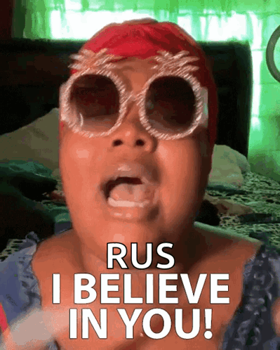 A Woman Wearing Sunglasses And A Red Hat Says Rus I Believe In You GIF