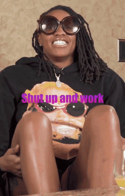 A Woman Wearing Sunglasses And A Shirt That Says " Shut Up And Work " GIF