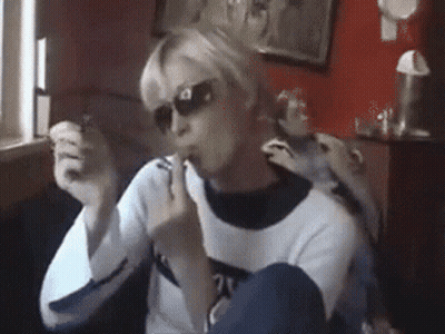 A Woman Wearing Sunglasses And A Sweater With The Number 21 On The Front GIF