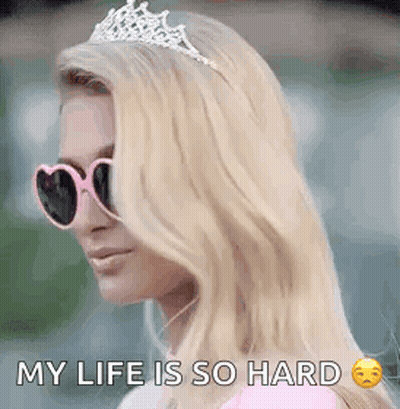 A Woman Wearing Sunglasses And A Tiara Is Saying `` My Life Is So Hard `` . GIF