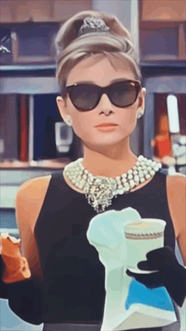 A Woman Wearing Sunglasses And Pearls Is Holding A Cup Of Coffee GIF