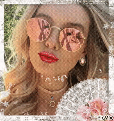 A Woman Wearing Sunglasses And Red Lipstick Is Surrounded By Flowers GIF