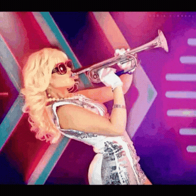 A Woman Wearing Sunglasses Is Blowing A Trumpet In Front Of A Purple Background GIF
