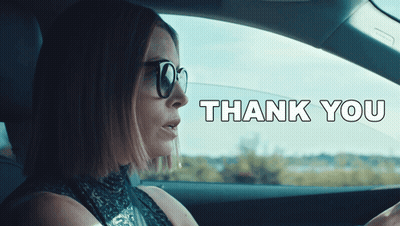 A Woman Wearing Sunglasses Is Driving A Car With The Words Thank You Written On The Bottom GIF