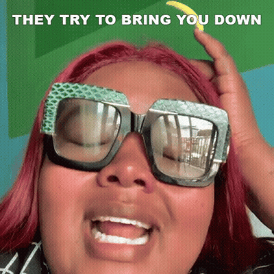 A Woman Wearing Sunglasses Is Making A Funny Face And They Try To Bring You Down GIF