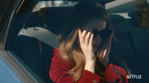 A Woman Wearing Sunglasses Is Sitting In A Car With A Netflix Logo On The Bottom GIF