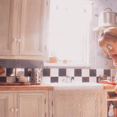A Woman Wearing Sunglasses Is Sitting In A Kitchen GIF