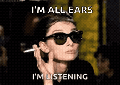 A Woman Wearing Sunglasses Is Smoking A Cigarette And The Caption Says I 'M All Ears I 'M Listening GIF