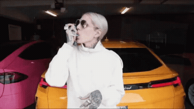A Woman Wearing Sunglasses Is Standing In Front Of A Ford Car GIF