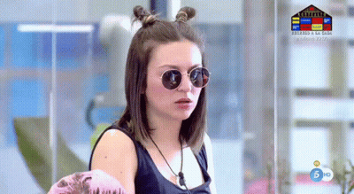 A Woman Wearing Sunglasses Is Standing In Front Of A Screen That Says 5 Hd On It GIF