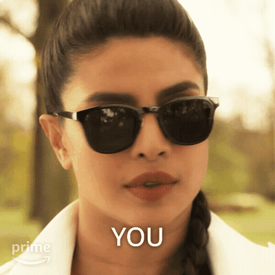 A Woman Wearing Sunglasses Says " You " In Front Of Her GIF