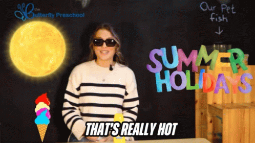 A Woman Wearing Sunglasses Stands In Front Of A Blackboard That Says Summer Holidays GIF