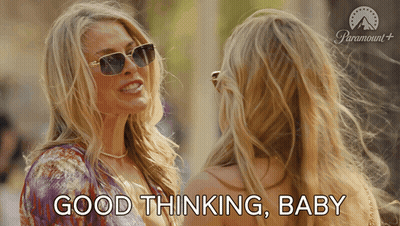 A Woman Wearing Sunglasses Talks To Another Woman And Says Good Thinking Baby GIF