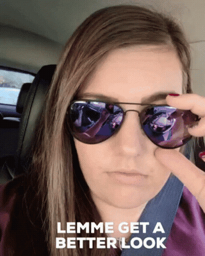 A Woman Wearing Sunglasses With The Words " Lemme Get A Better Look " Below Her GIF